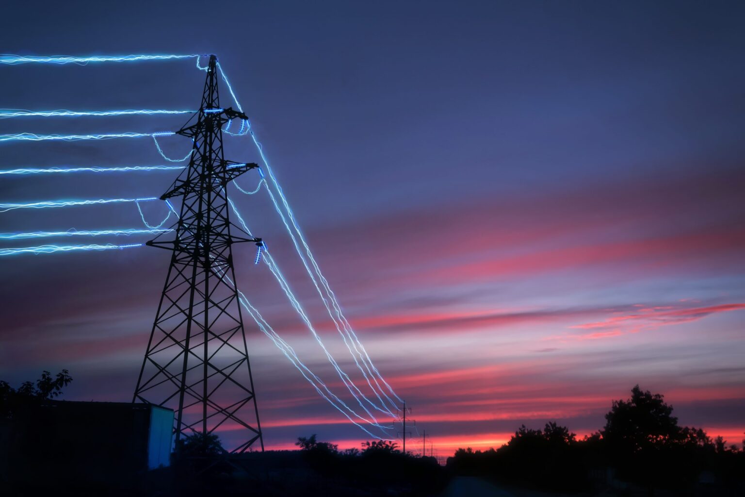 Electric,Transmission,Towers,With,Glowing,Wires,Against,The,Sunset,Sky Electric,Transmission,Towers,With,Glowing,Wires,Against,The,Sunset,Sky